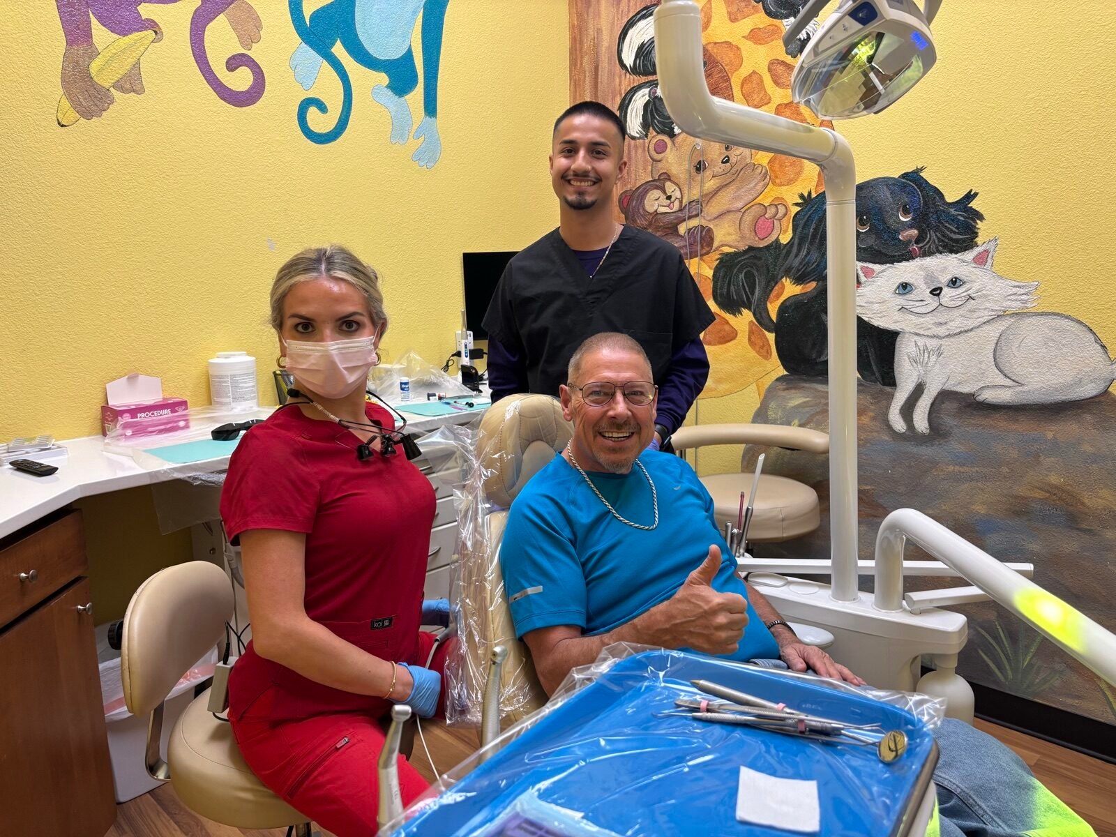 Adult patient with the Star Dental team in a treatment room