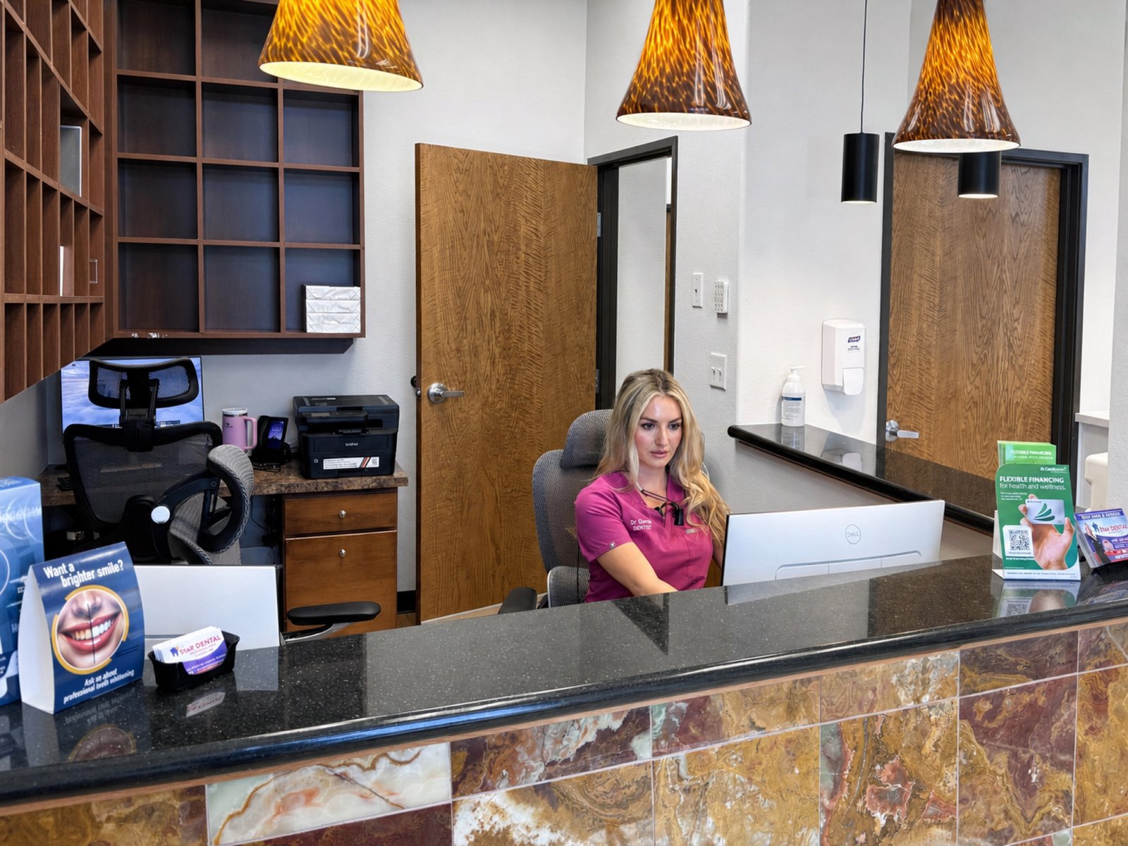 Star Dental reception team helping patients understand Medicaid dental coverage in Denver