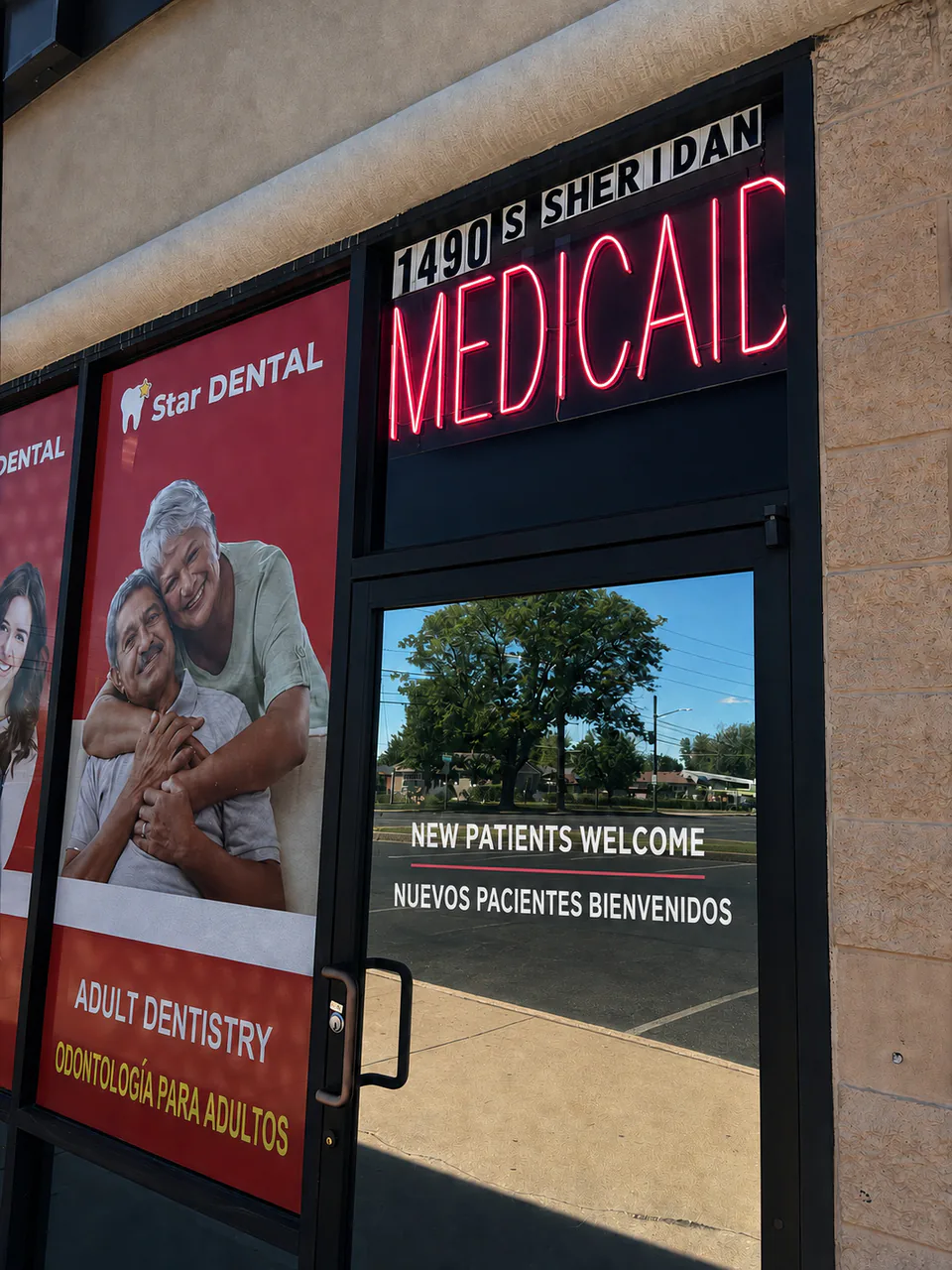 Star Dental entrance at 1490 S Sheridan Blvd in Denver, with a Medicaid sign and English and Spanish new-patient welcome signs